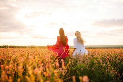 Two Beautiful woman in a field. Nature, fashion, vacation and lifestyle.
