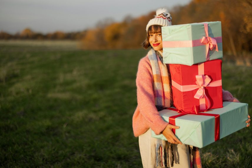 Woman carries New Year's gifts outdoors