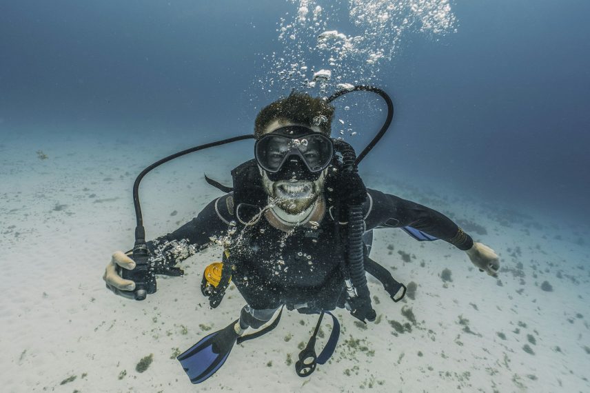 scuba diver taking out the primary regulator